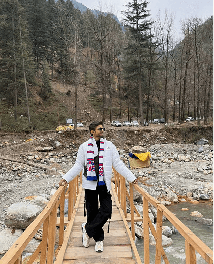 Walking across a wooden bridge by a river