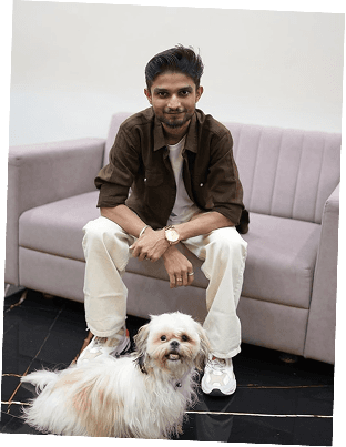 Aman sitting with his dog
