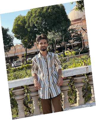 Aman standing near a garden terrace