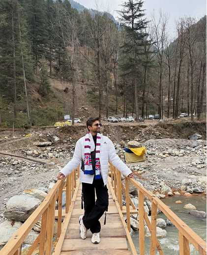 Walking across a wooden bridge by a river
